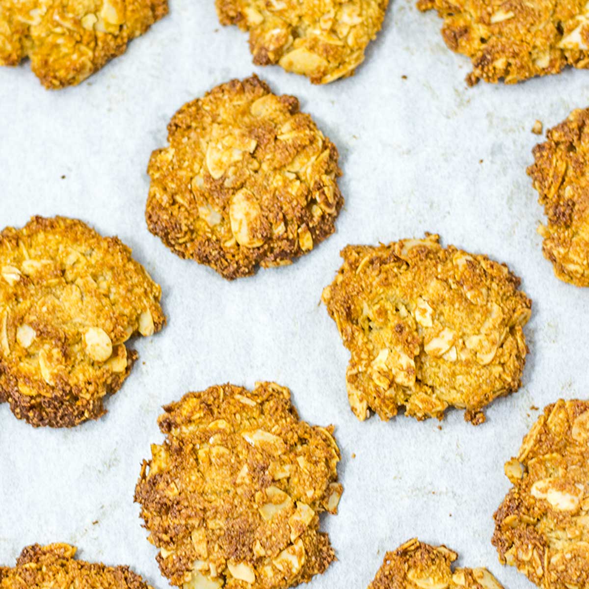Keto Anzac biscuits on a cookie sheet.